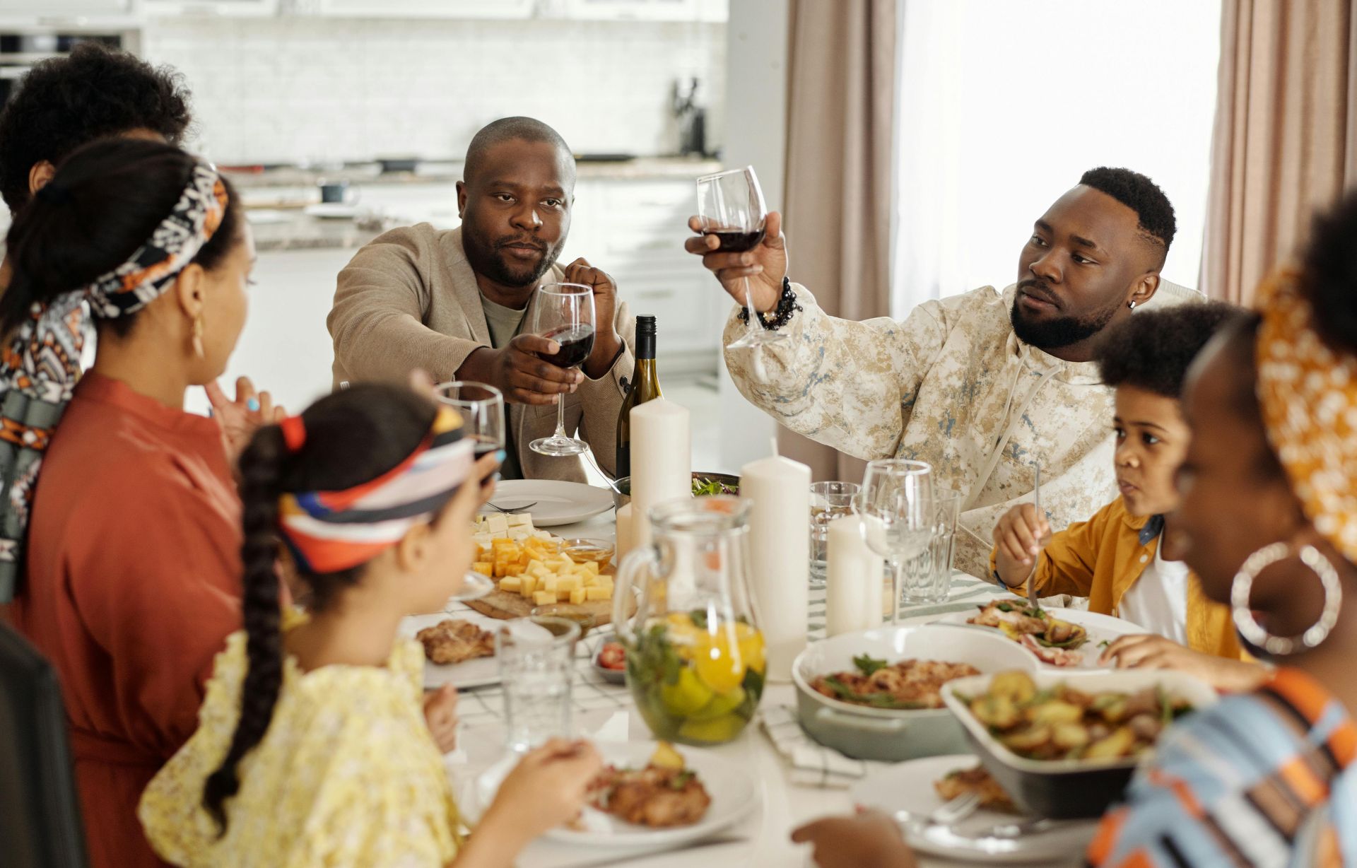 A joyful family dinner with wine toasts bringing together adults and children in a warm home setting.
